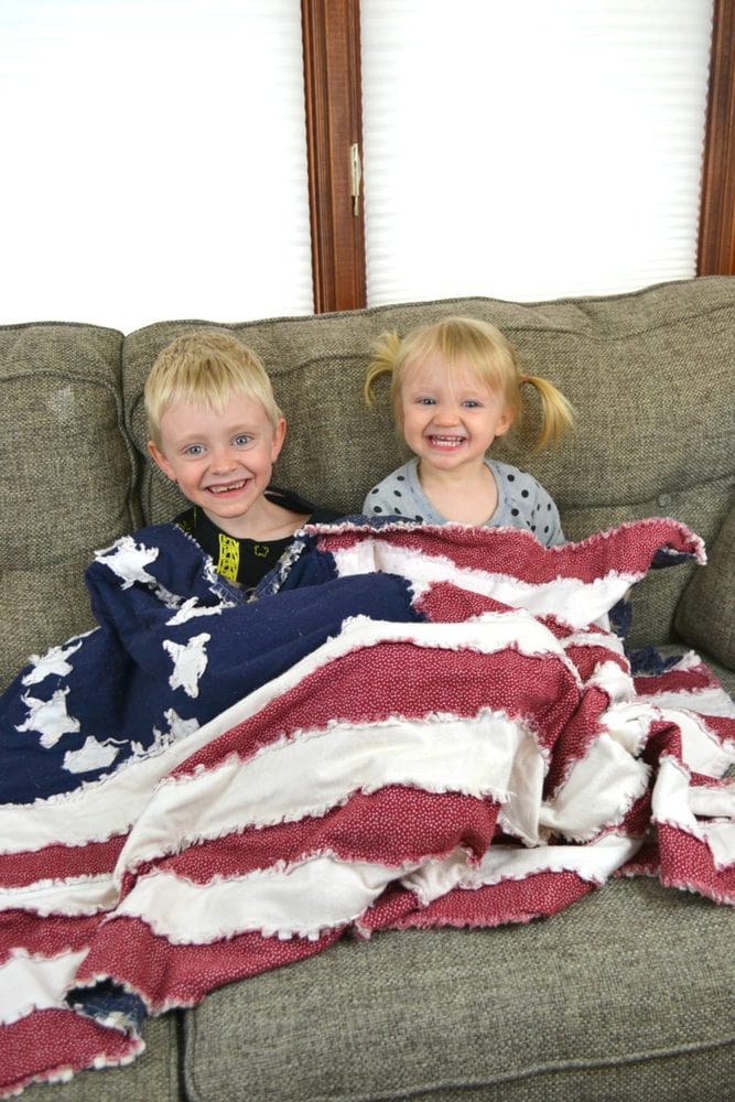 kids sitting with a flag rag quilt