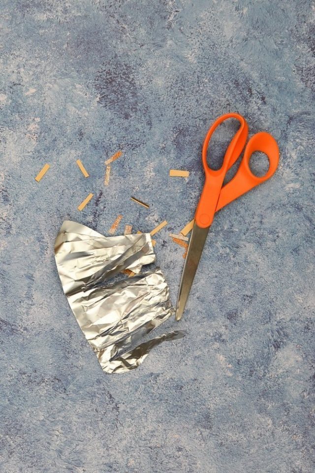 cut scissors into aluminum foil and sandpaper