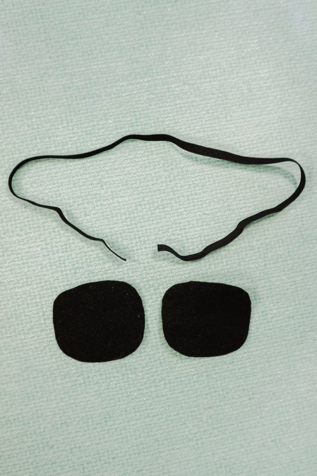 cut out elastic to fit head and two black felt ovals