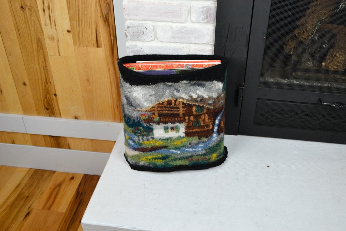 DIY storage baskets from old clothes with a finished basket made from a felted wool sweater holding books