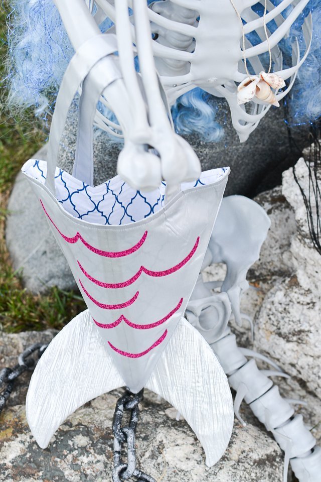 holding mermaid tote bag