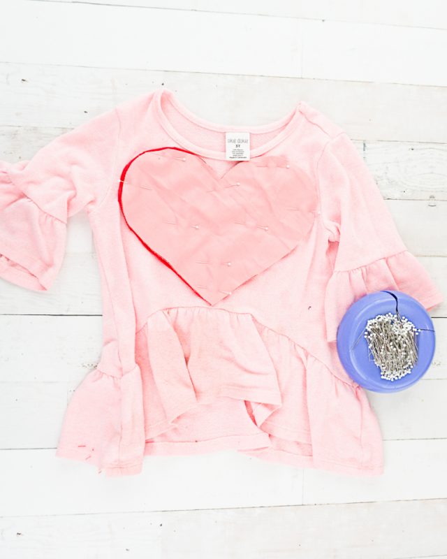 pin hearts onto shirt