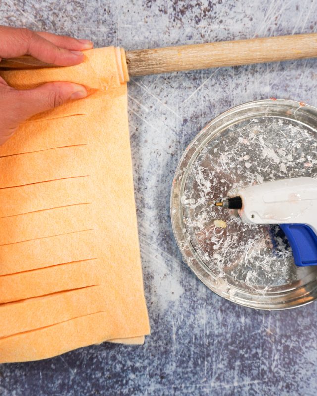 roll the felt around the stick and keep gluing