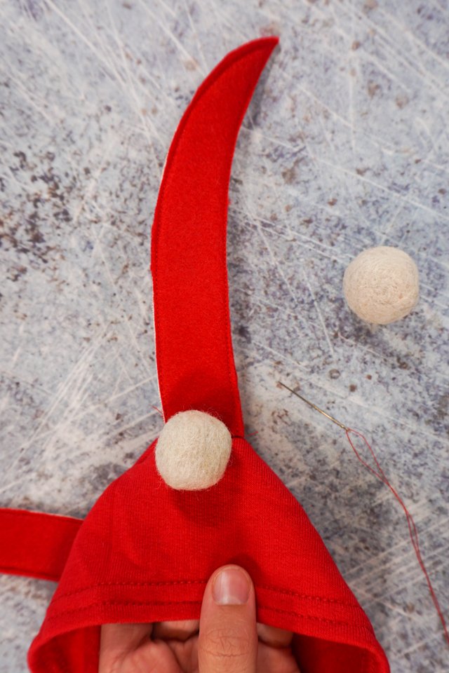 sew white felt balls at base of antennae