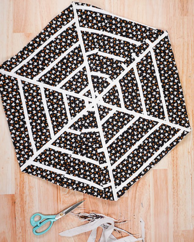 sew around the spiderweb to quilt the layers