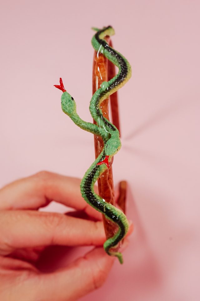 hot glue two snakes onto headband