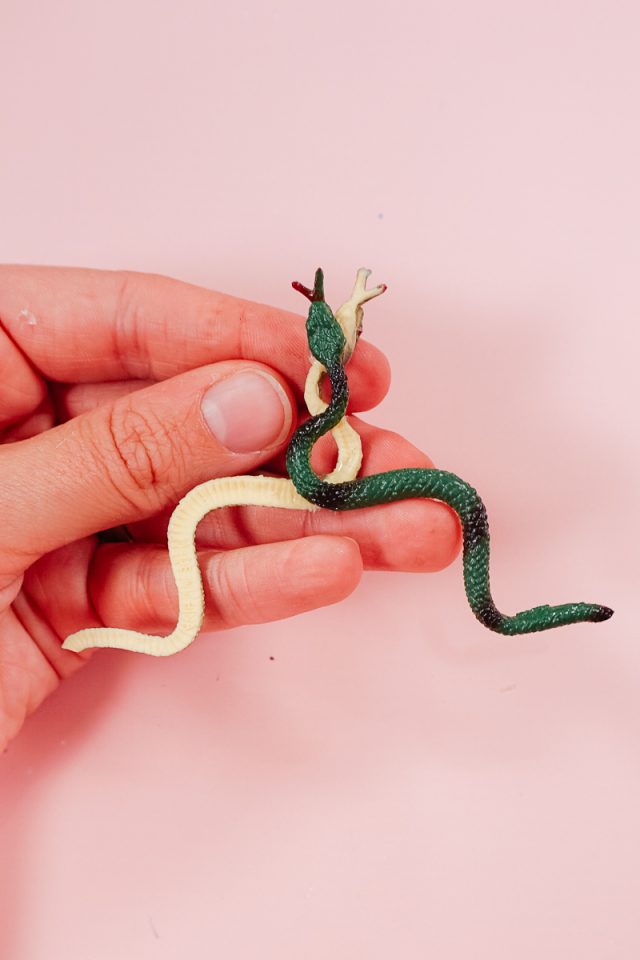 hot glue two snakes in an upward formation