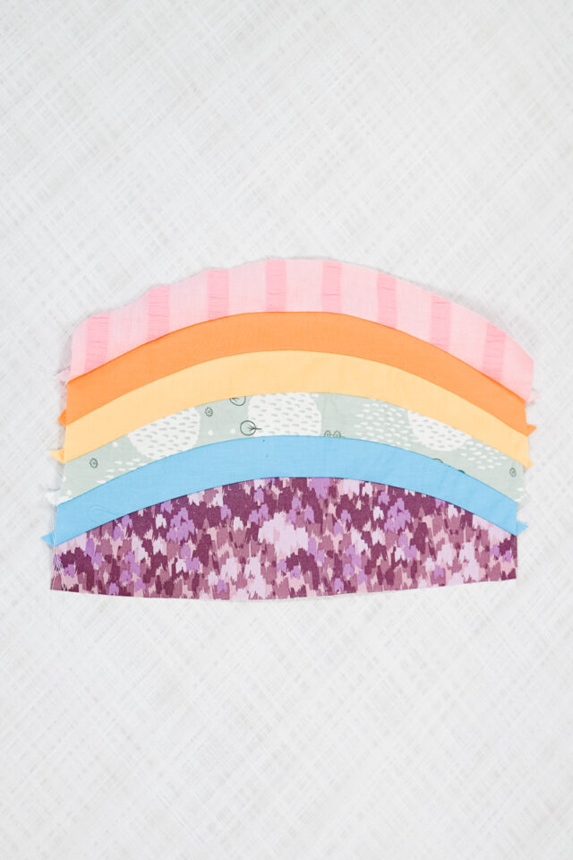sew the curved pieces together to create stripes or a rainbow