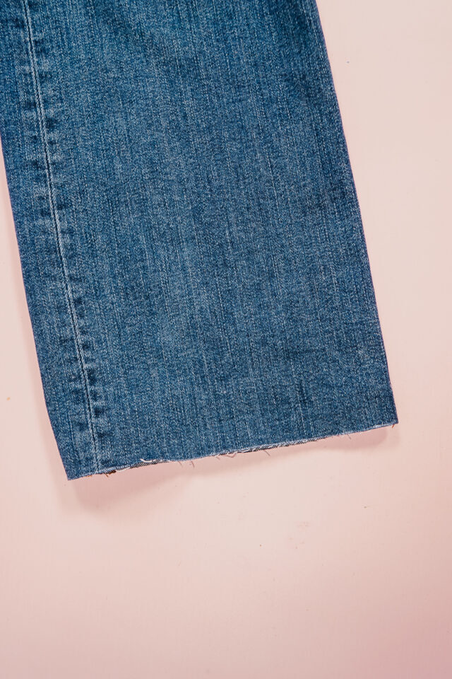 remove mark and wash or pull at hem to fray slightly