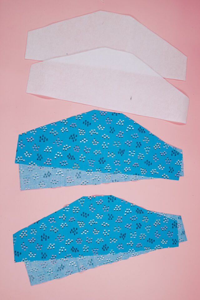 cut out pieces of fabric and iron-on fleece