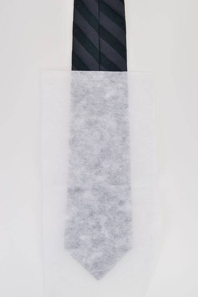 place tear-easy stabilizer on the back of the tie