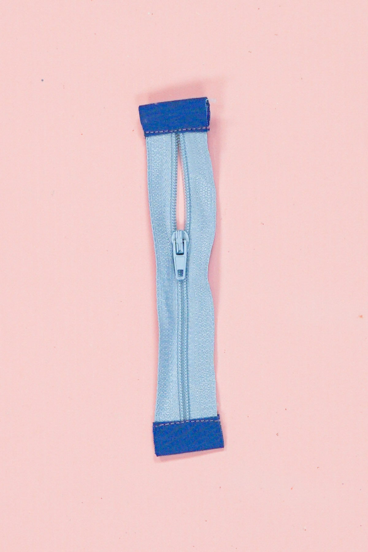 sew tabs onto zipper ends