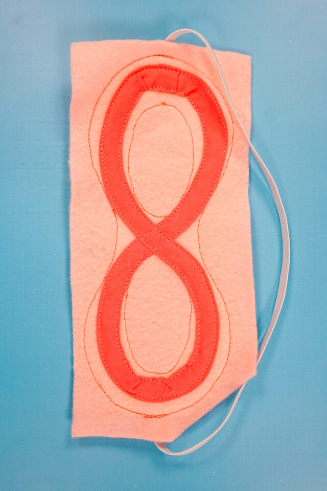 optionally sew detail onto felt