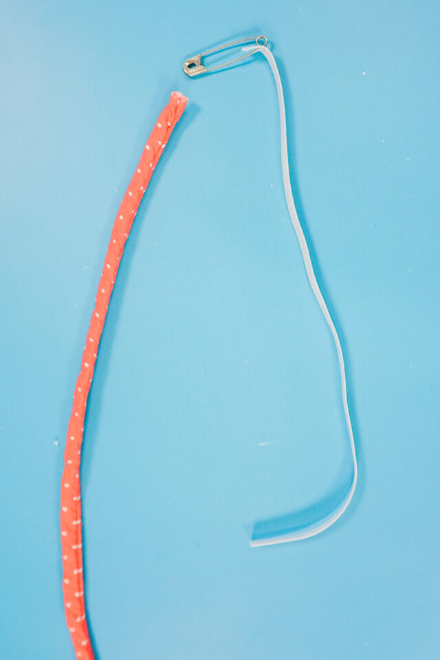 use safety pin to slide elastic into the tube