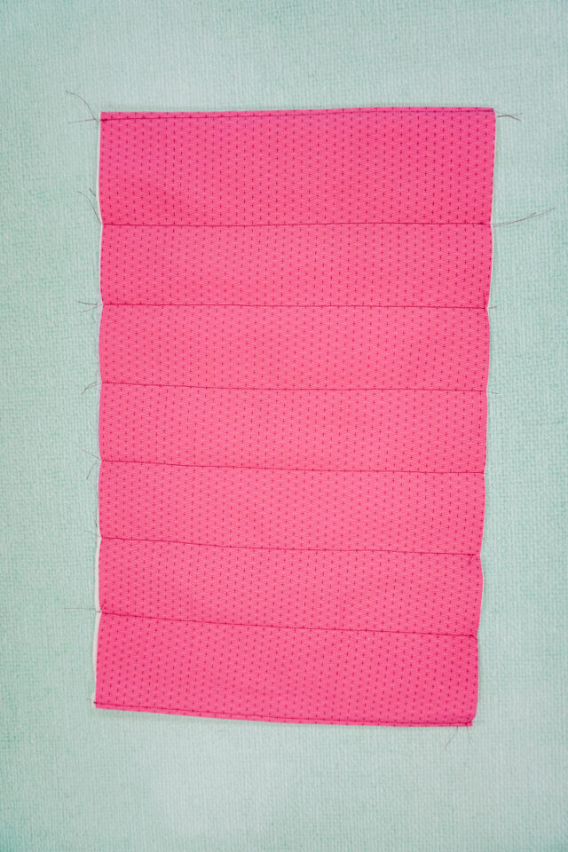 quilt lines parallel with short ends to secure batting