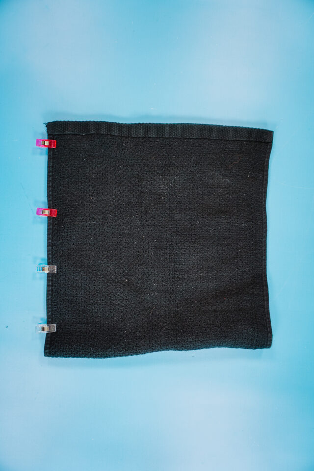 fold towel and clip one side together adjacent to the fold