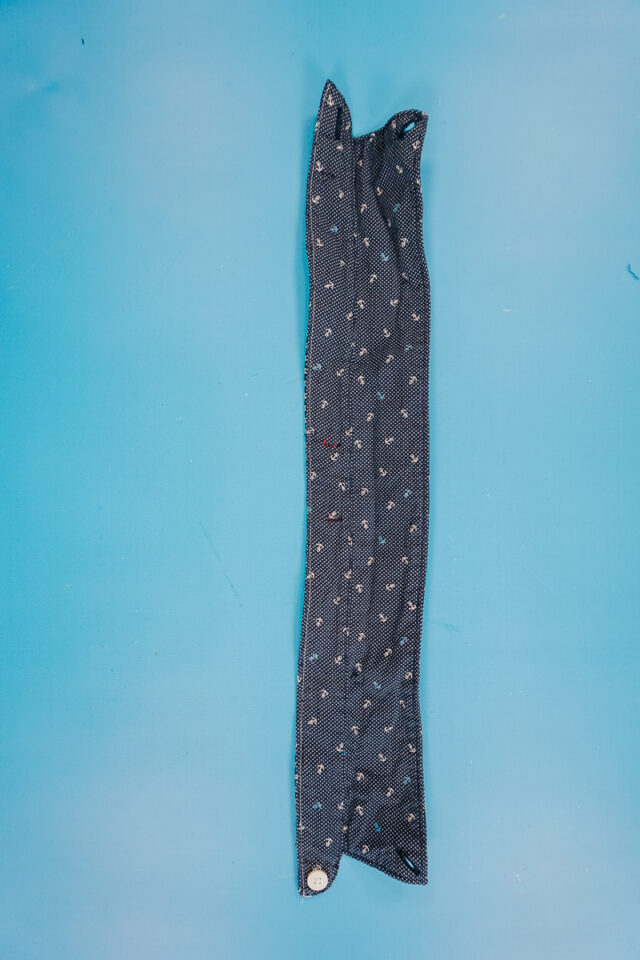 sew the bottom of the shirt collar closed by pinching the layers together
