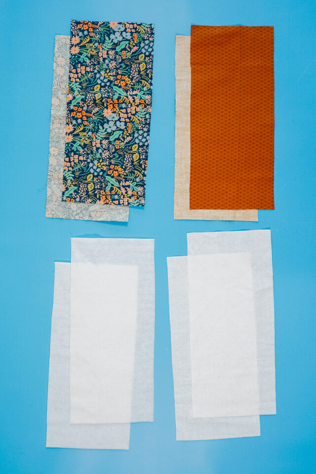 cut out 4 pieces of fabric, 2 pieces of interfacing, and 2 pieces of fusible fleece