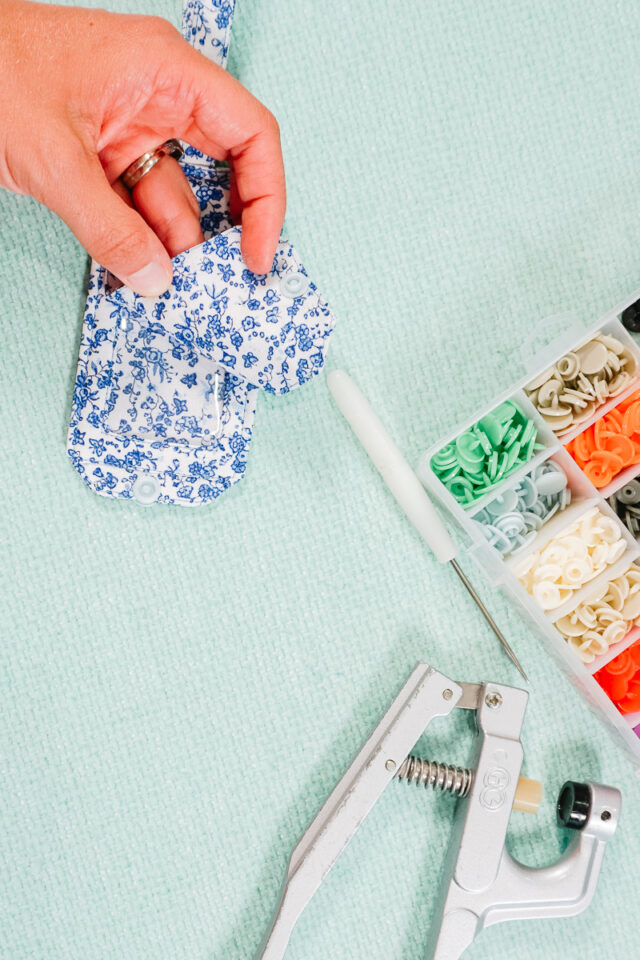 add plastic snaps to the other side of the flap