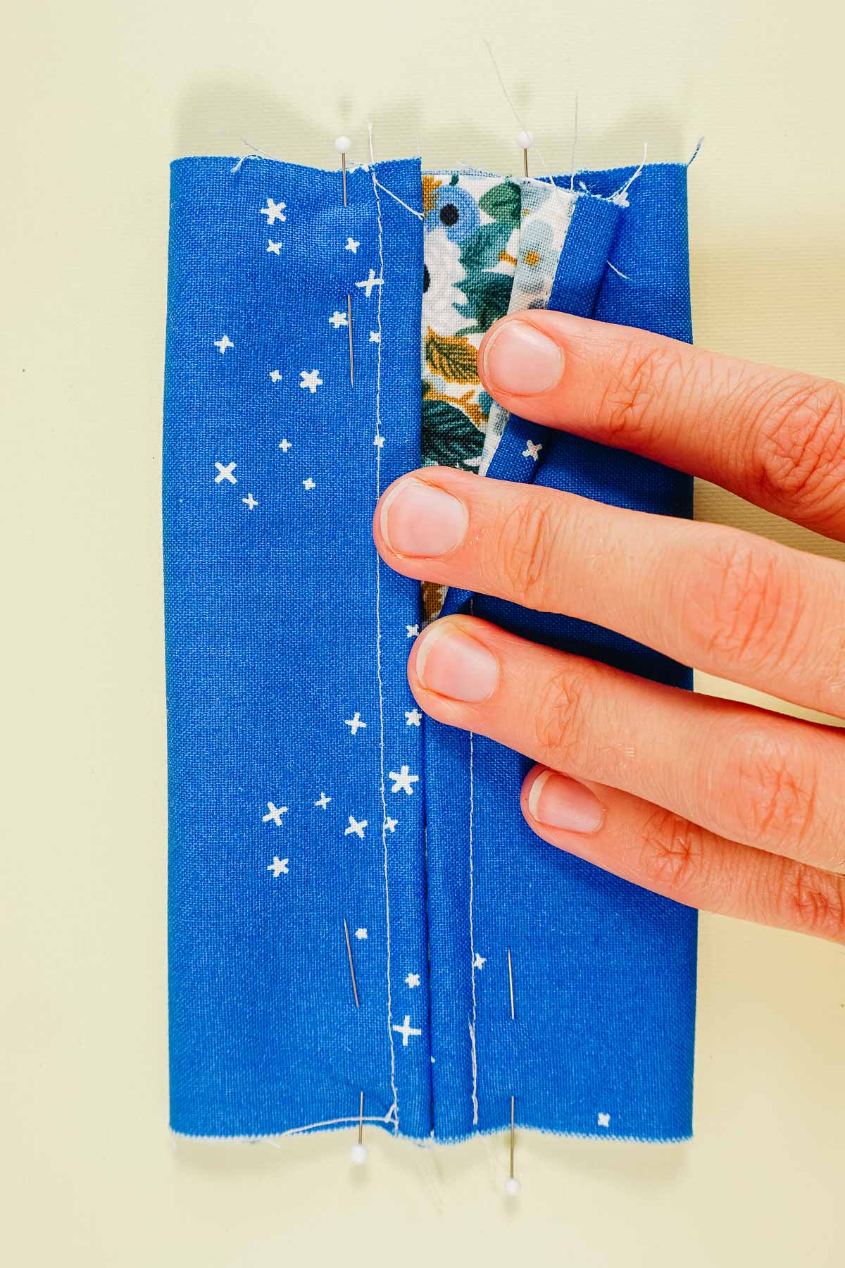 fold finished edges in to meet at the center with outer sides facing each other