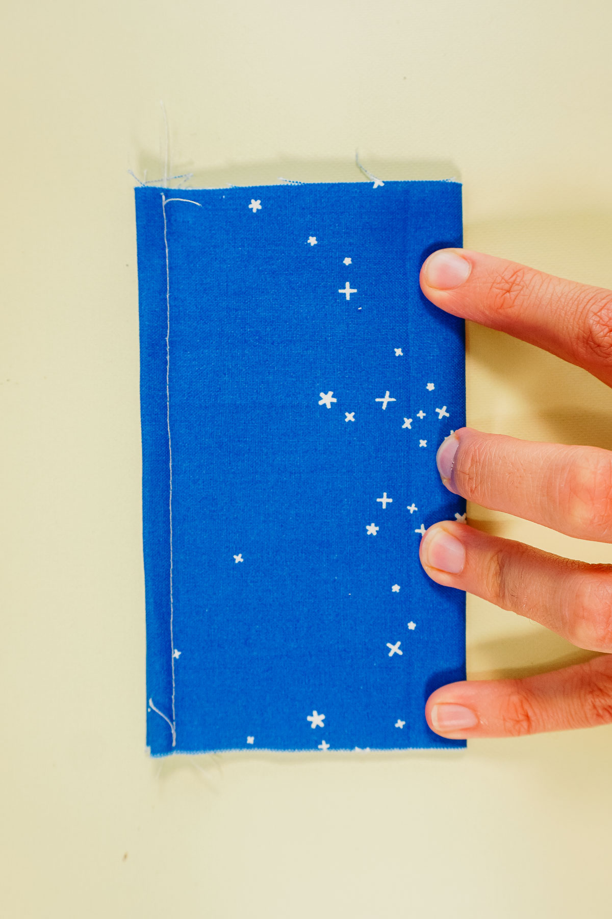 fold the tissue holder in half matching the finished edges to find the center