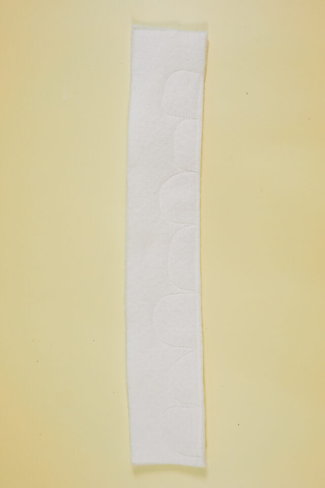 sew teeth shapes onto two layers of white felt