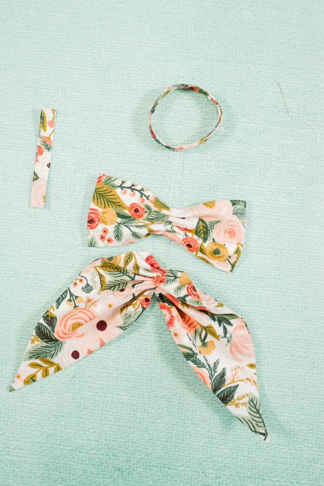 sew from the bottom of the tails gathered section, through the ears, and through the loop.