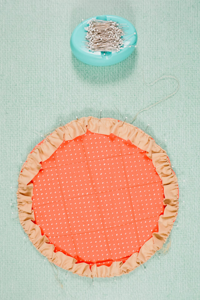 gather the ruffle and pin it onto the outside of the circle