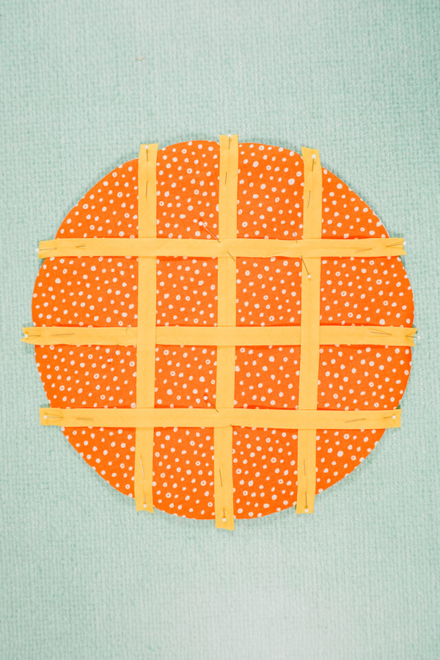 cut and place single fold pieces woven across fabric, batting, and fabric