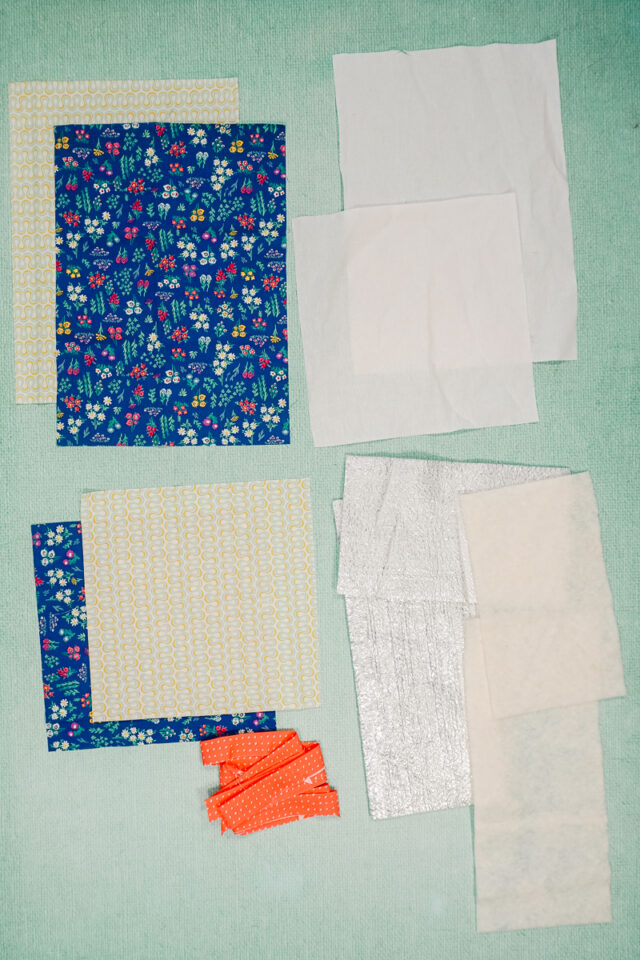 cut pieces of fabric, interfacing, and batting