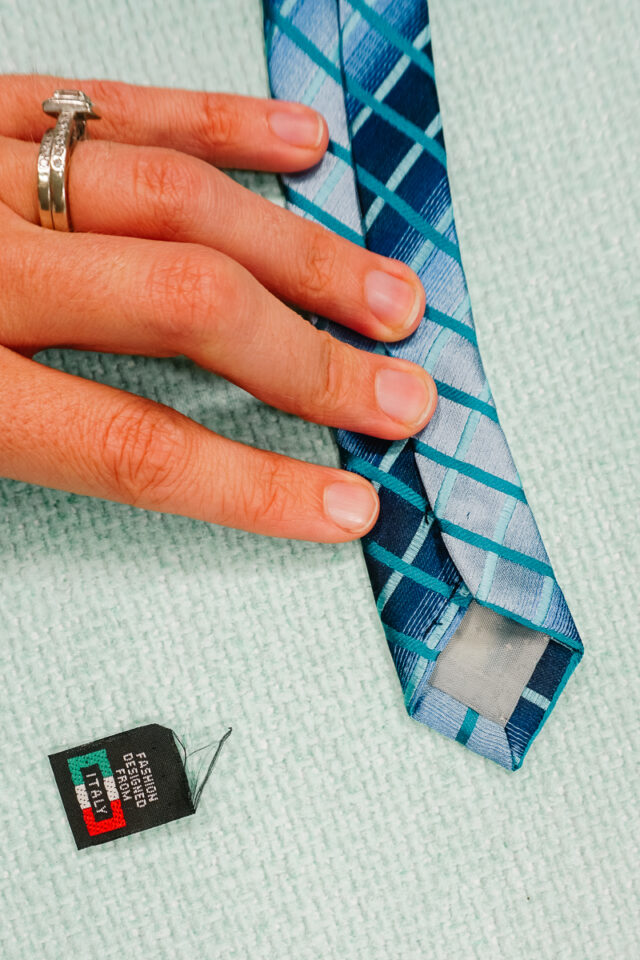 some tags you have to seam rip and then sew the seam closed again
