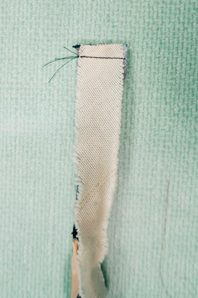 slide lobster clasp into cut edge. Sew the cut edge closed.