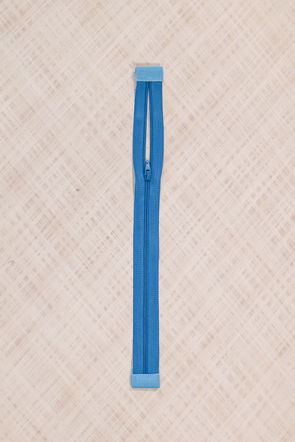fold zipper tab around to back enclosing raw edges and topstitch in place