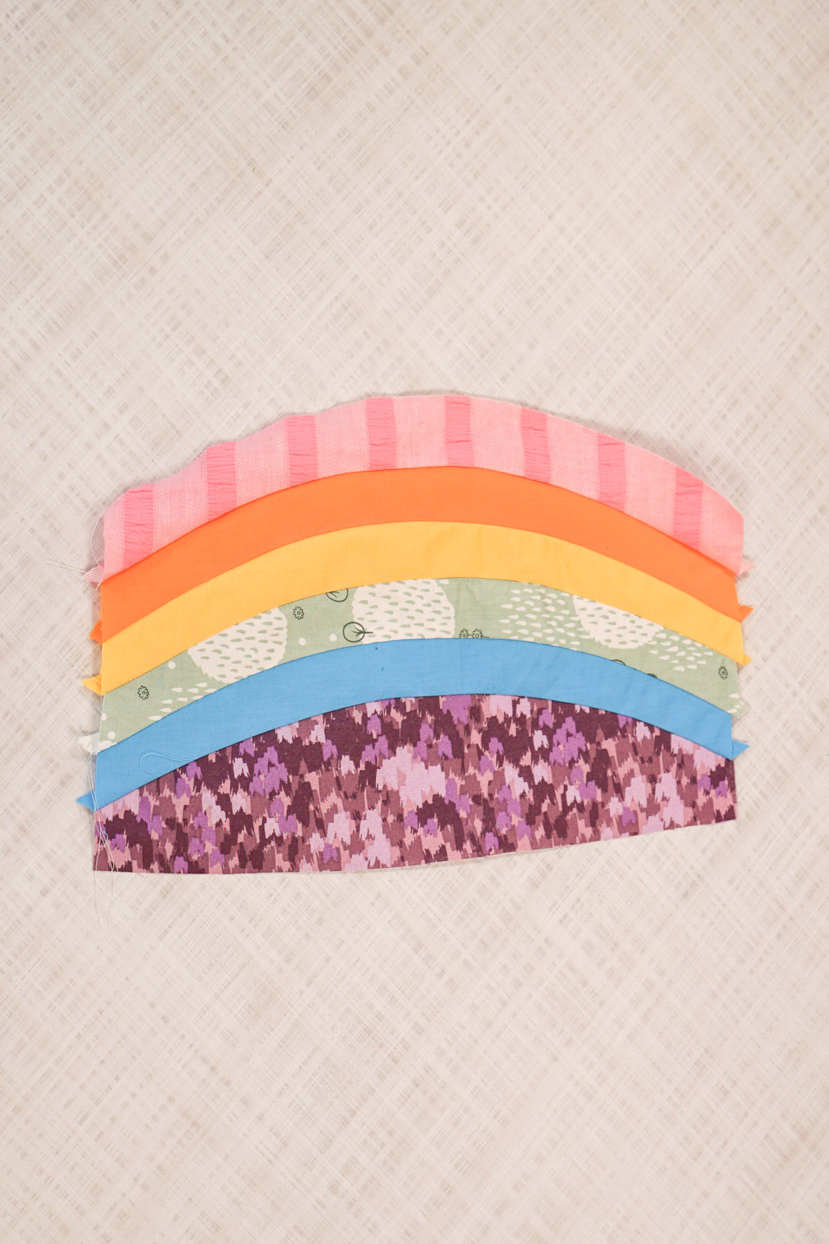 sew the curved pieces together to create stripes or a rainbow