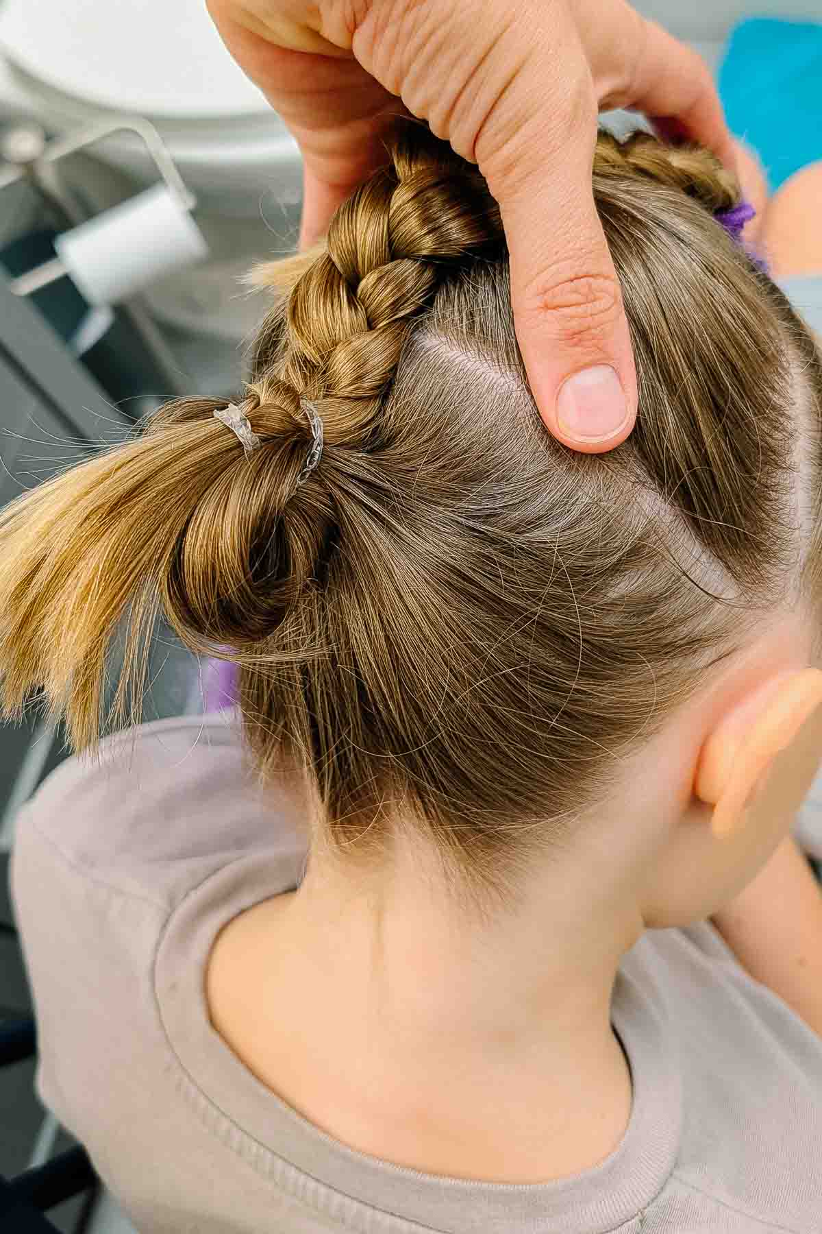 braid hair. combine braid and hair into bottom ponytail. do a pull through bun or a regular bun.