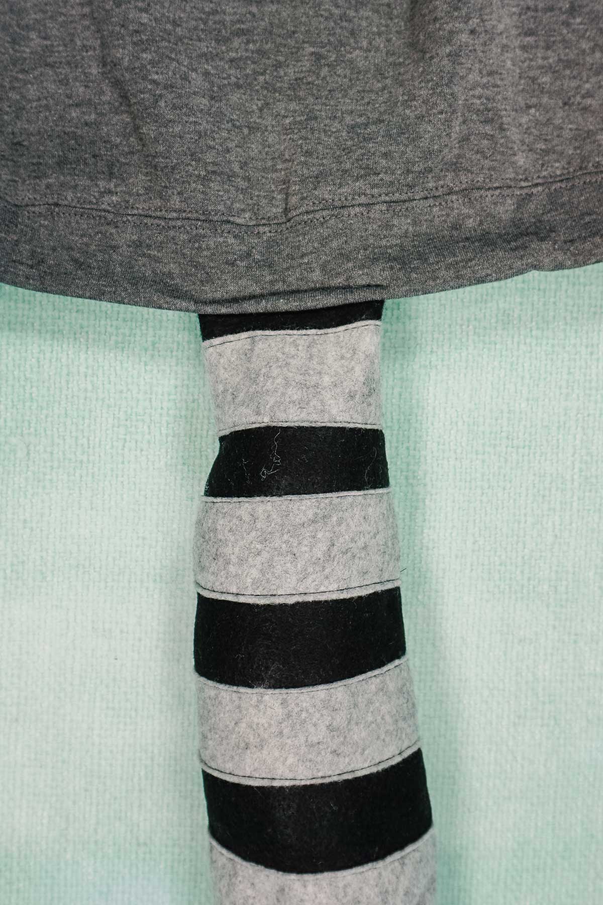 sew the tail on to the back of the hoodie