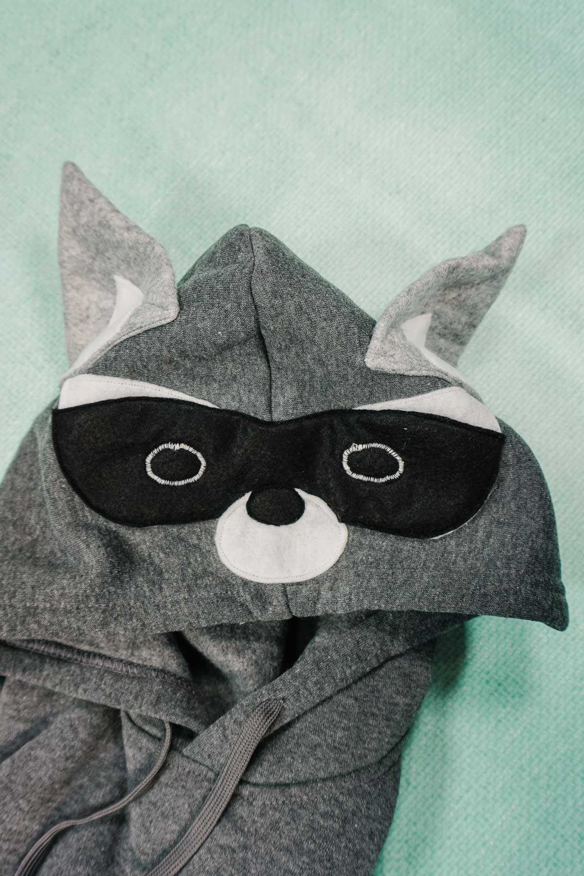 sew ears, mask, and muzzle onto hood