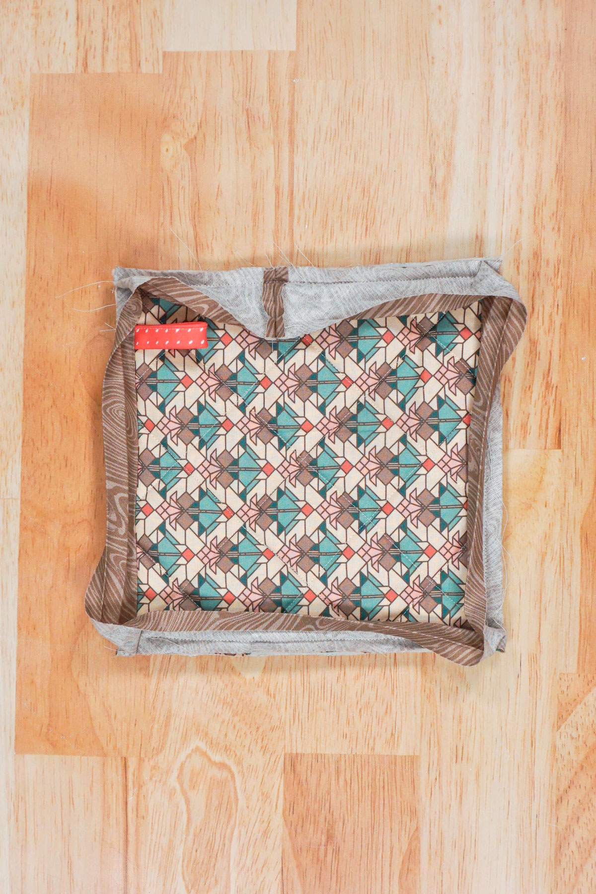 sew the bias binding on all edges with mitered corners